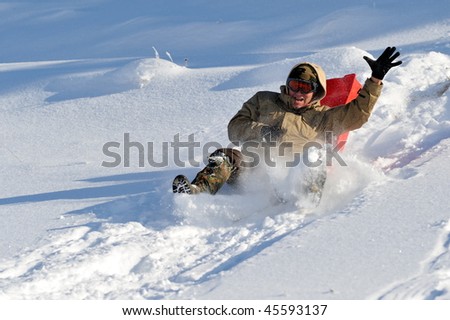 young man with sled in the snow