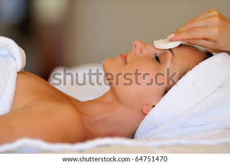 Profile view of a happy young woman preparing for cosmetic treatment