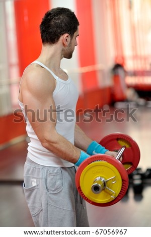 young handsome man exercising in the gym