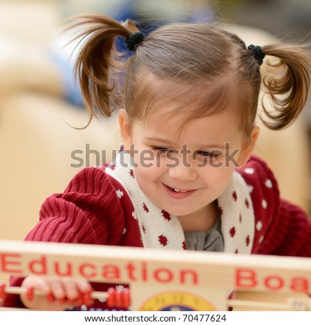 cute little girl using education board