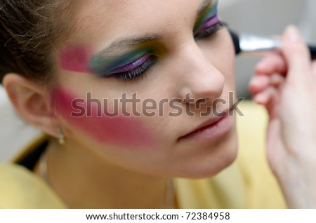 beautiful young model getting fashion make-up