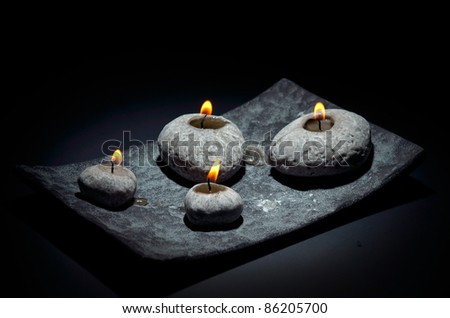burning candles isolated on black