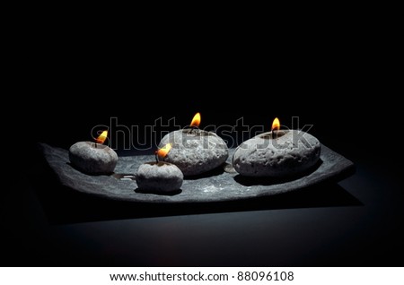 burning candles isolated on black