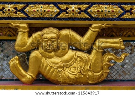 Asian golden demon statue in a sitting position