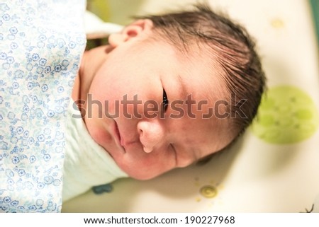 New born male Thai baby in various sleeping action, taken without flash