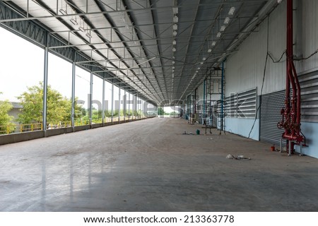 An empty warehouse road way for goods receiving, taken indoor