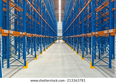 Inside an empty large generic warehouse with rack in place, taken in door