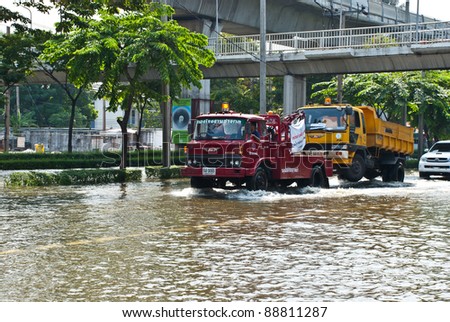 BANGKOK - NOVEMBER 7 : Heavy truck is toed by service truck after impact with heaviest flood and rain in 20 years in the capital on November 07, 2011 in Bangkok, Thailand.