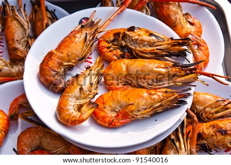 Flame grilled large prawns on white plates, use for seafood, health and wellness related concepts