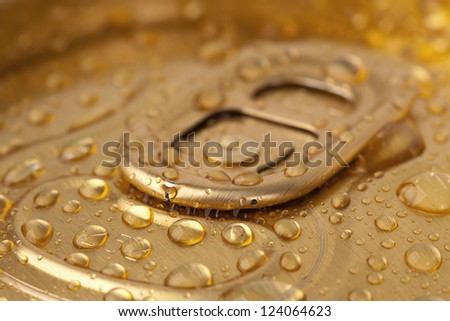 Top beer cans in drops close-up