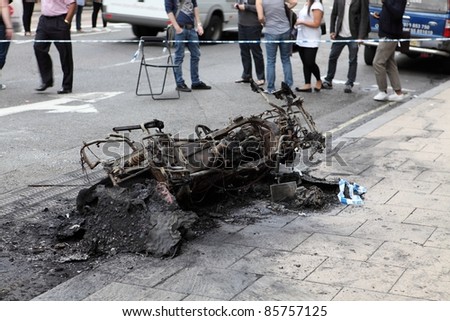 LONDON, UK - AUGUST 6: On day one of a 4-day riot, a burnt motorcycle lies in the street on August 6, 2011 in London, UK. Riots started after police shot Mark Duggan. It caused 200 million in GBP damage, 3,100 arrests and five deaths.