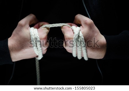 Criminal hands holding a rope