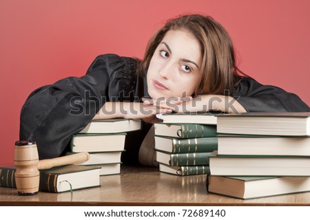 Young law school student surrounded by statute books