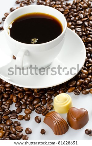 Coffee cup on a lot of coffee  with chocolate candy