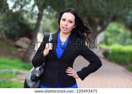 young brunette woman in the park