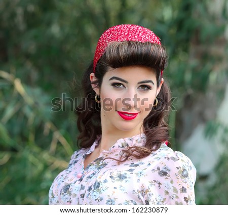 Beautiful young woman with pin-up make-up and hairstyle