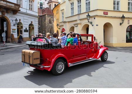 Prague, Czech Republic - April 25, 2015: Tour of the city on an old car with unidentified people . Prague is the capital and largest city of the Czech Republic