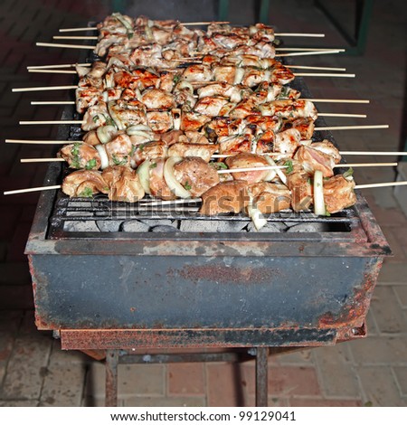 Barbecue sticks with chicken meat, onion and pepper slices - night shot