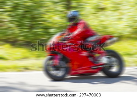 Fast moving motorcycle racer blur background