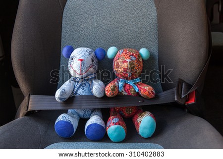 Stuffed toys buckled with safety belt in a car