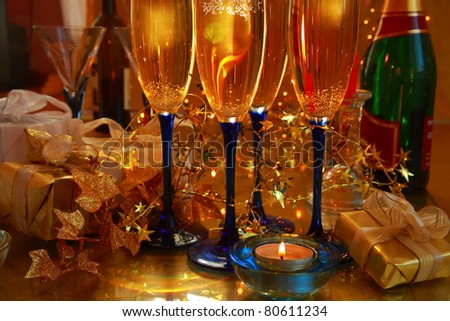 Closeup of champagne in glasses,gift box and lights on background.
