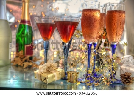 Champagne and wine in glasses,bottles,gift boxes and twinkle lights on background.