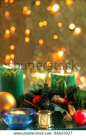 Christmas decoration with baubles,candle lights and golden background with twinkle lights.