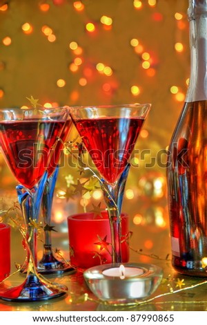 Champagne in glasses,candle lights and twinkle lights on golden background.