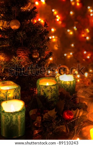 Christmas decoration with candle lights,christmas tree, baubles an twinkle lights on background.