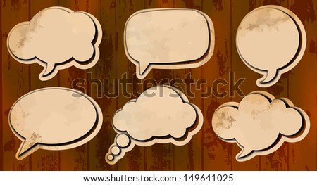 Set of speech bubbles cut out from aged paper