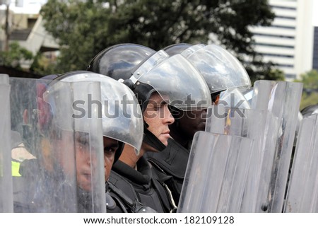 CARACAS, VENEZUELA - MARCH 16, 2014: State police blocking the passage of the protesters who claim for violations of human rights and the killing of civilians in peaceful demonstrations