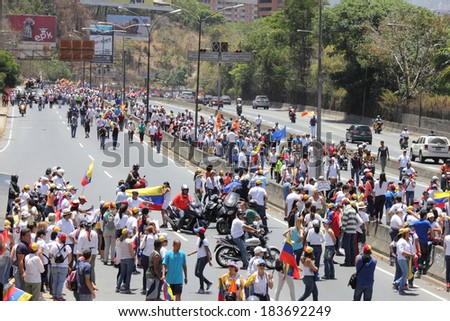 CARACAS, VENEZUELA - MARCH 22, 2014: Venezuelans protest in the street against the government for human rights violations and killings of civilians in peaceful demonstrations