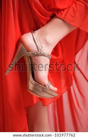 Golden formal shoe and red dress