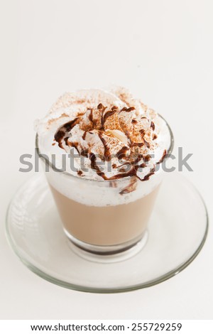 Cup of cappuccino with cream and chocolate