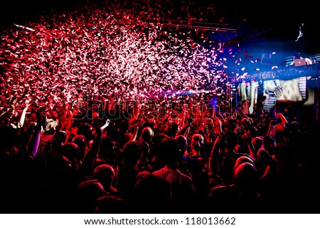 Audience Crowd Silhouette Confetti Explosion While Dancing to DJ Pete Tong at Cream Nightclub Party. Nightlife Lazer Show Hands In Air with Confetti
