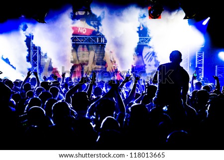 Audience Crowd Man on Shoulders Silhouette Dancing to DJ Pete Tong at Cream Nightclub Party. Nightlife Lazer Show Hands In Air With Smoke Cannon Blast