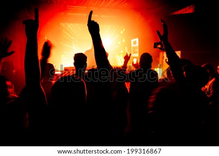 Hands in the air silhouette at nightclub party rave