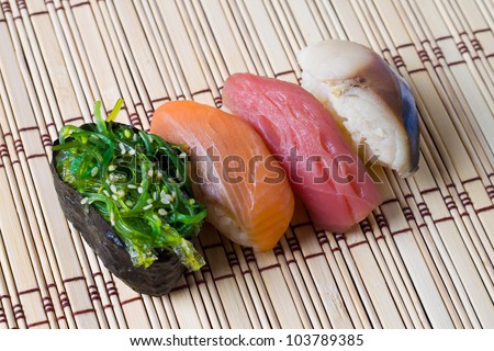 Japanese tradition food, Sushi  made of salmon, seaweed, tuna  and mackerel with  rice on wood  bamboo  mat