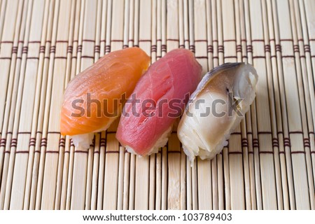 Japanese tradition food, Sushi  made of salmon, seaweed, tuna  and mackerel with  rice on wood  bamboo  mat
