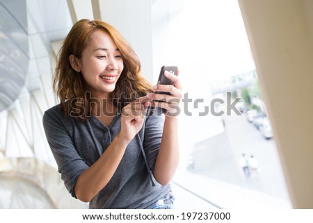 Business asian woman using smart phone in the modern building