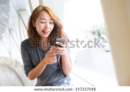 Business asian woman using smart phone in the modern building