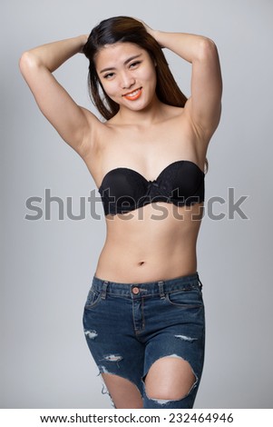 Young asian woman posing in sexy jeans