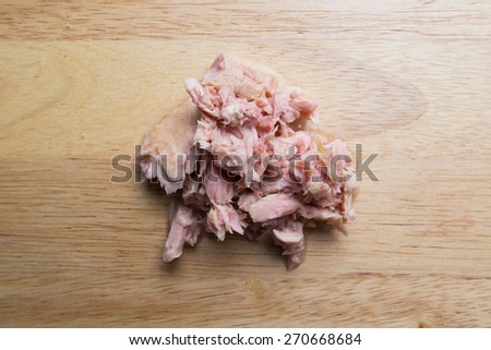 Canned tuna meat on wood background