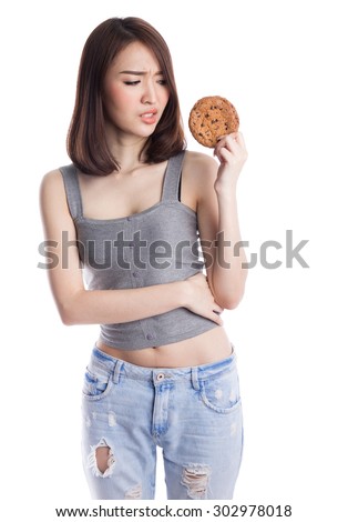 Young asian woman thinking, not eating, boring chocolate chip cookies, isolated on white background.