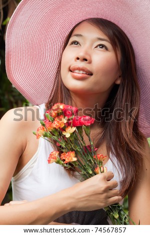 A girl with bouquet of flowers in her hand thinking of someone