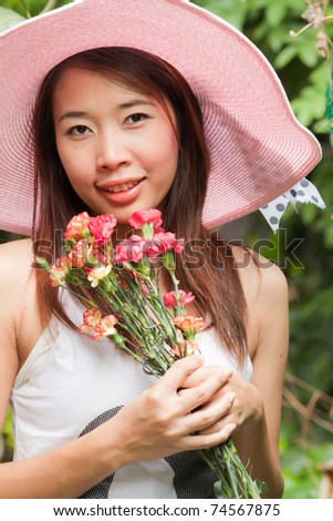 A girl with bouquet of flowers in her hand thinking of someone
