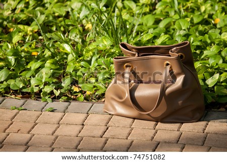 Lady Hand bag on the floor at sunset