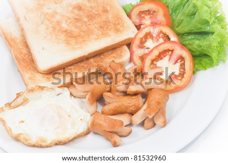 Sausage, toasted bread, and fries egg in plate for breakfast