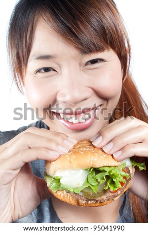 Young woman going to eat burger, shallow  depth of field,  focus at woman\'s face