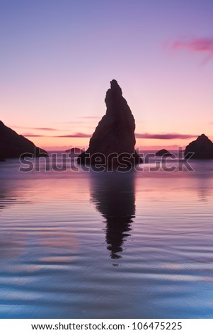 Bandon, Oregon is stock full of sea stacks.  This one in particular looks like a wizard hat as the receding waves allow for a colorful reflection.